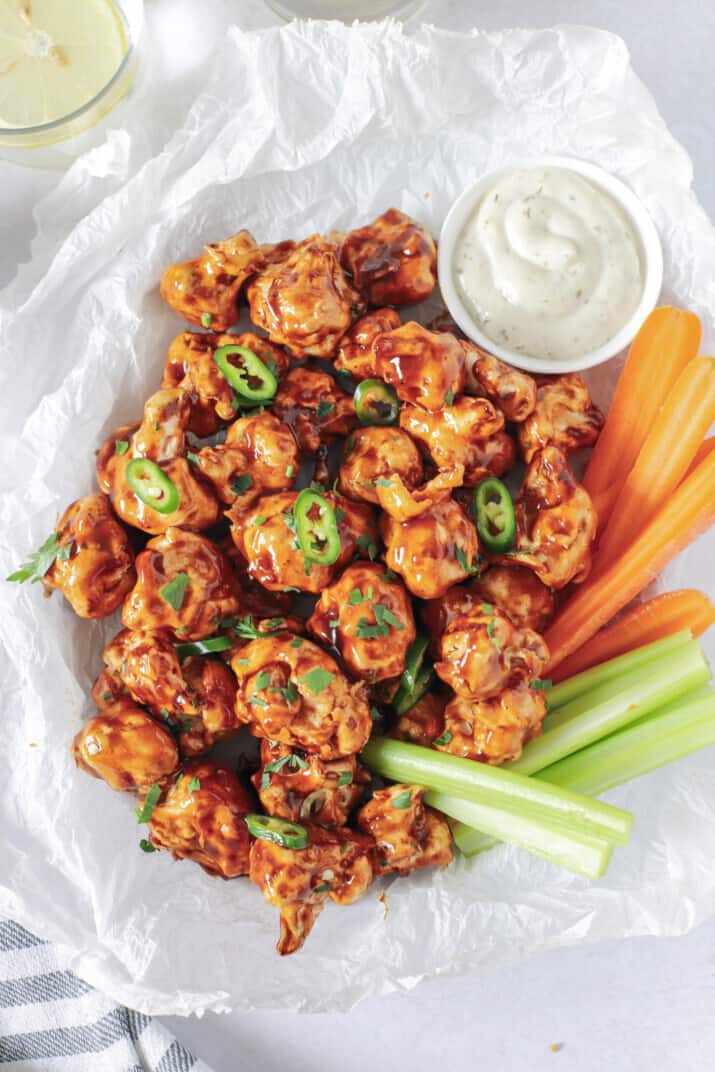 air fryer cauliflower wings tossed with honey bbq sauce in a basket