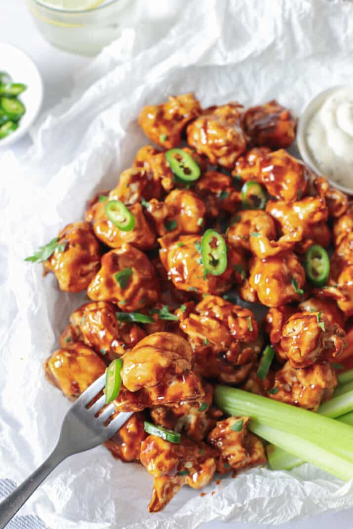 fork holding a air fryer honey bbq cauliflower wing