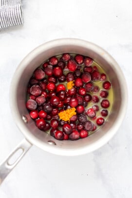 frozen cranberries with orange juice in a pot