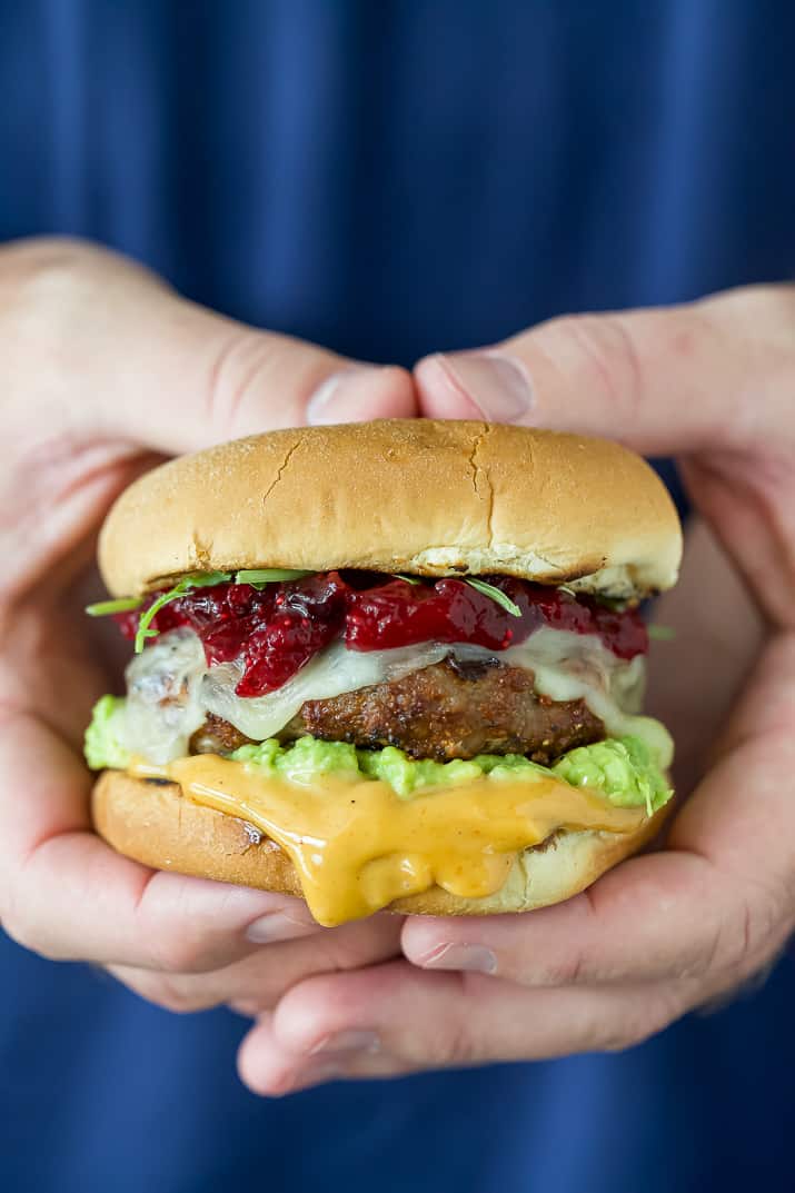 hands holding a turkey burger with spicy mayo