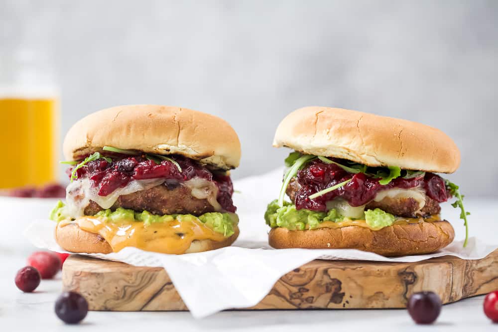 two avocado turkey burgers topped with cranberry chutney