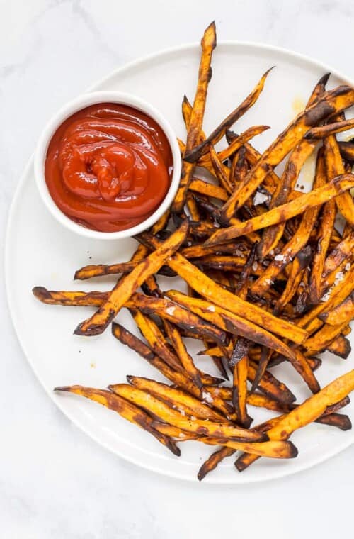 sweet potato fries on a plate with ketchup