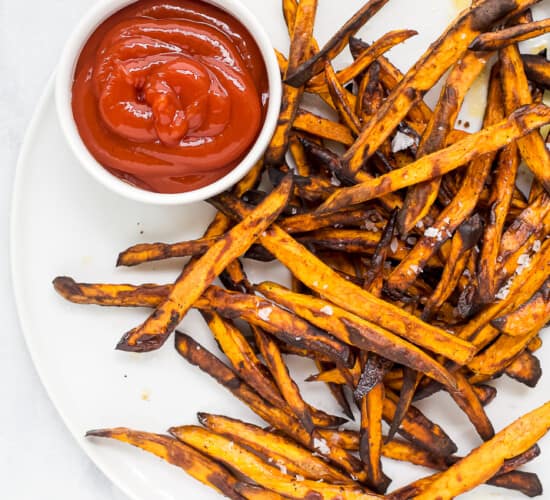 sweet potato fries on a plate with ketchup