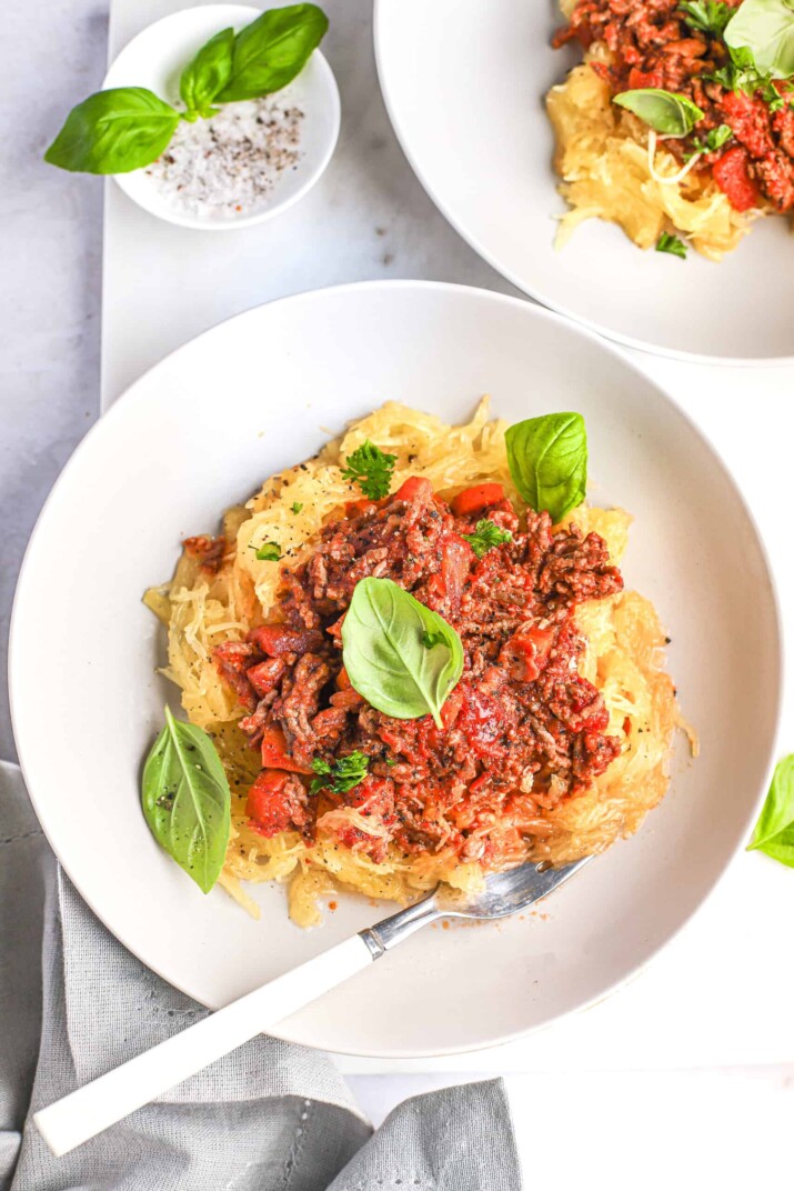 A bowl of homemade spaghetti squash pasta with bolognese sauce poured on top