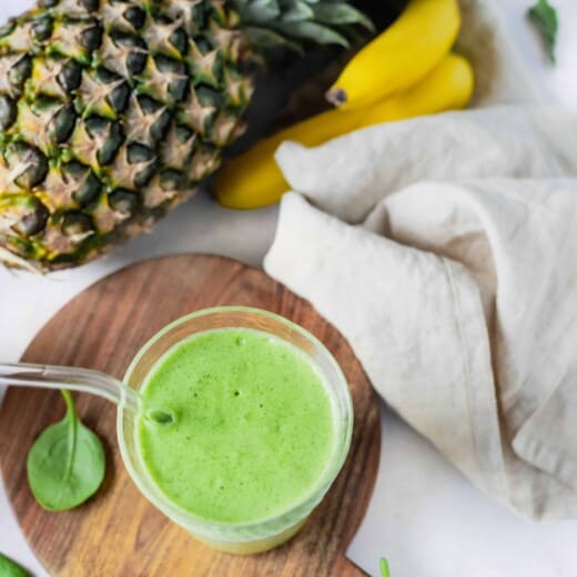 tropical green smoothie in a cup with pineapple