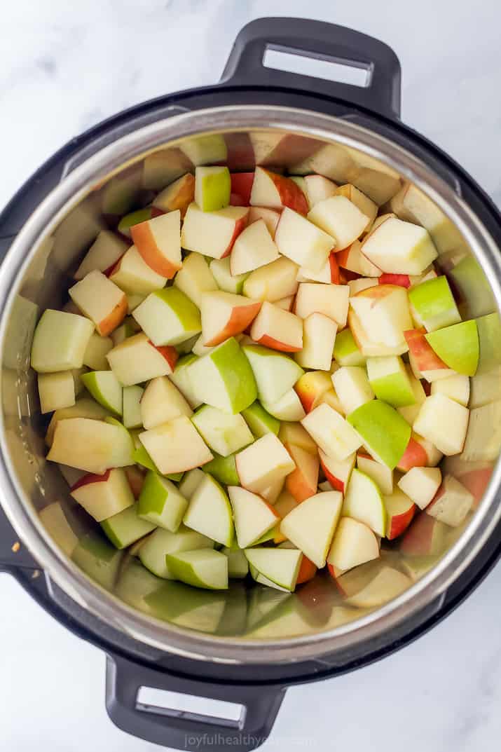 The inner pot of an Instant Pot containing chopped Honey Crisp and Granny Smith apples