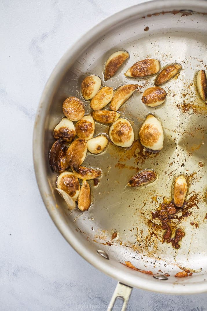 Garlic cooking in a pan with ghee.