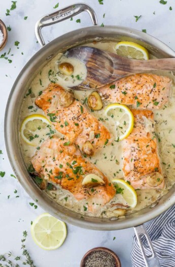 pan seared salmon with garlic cream sauce in a pan