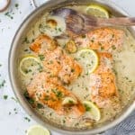 whole30 salmon in a skillet with garlic cream sauce