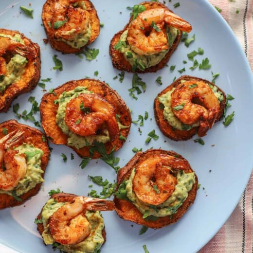 Seven shrimp appetizer bites arranged neatly on a baby blue plate