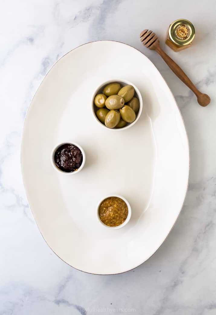 cheese board platter with olives fig jam and mustard