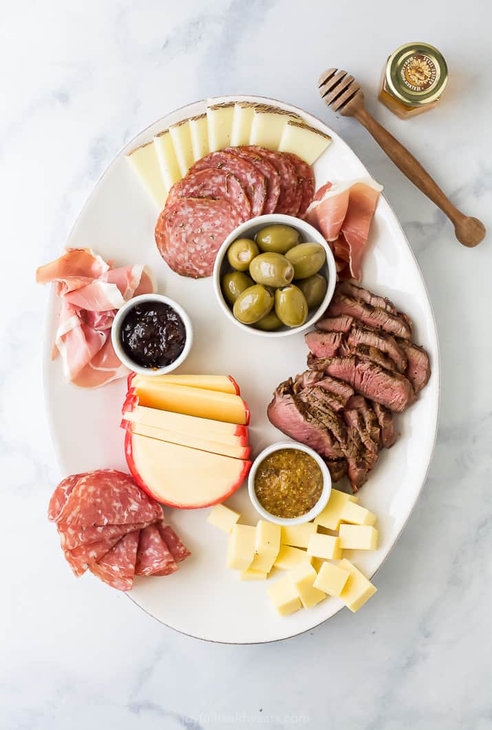 platter with cheese meats and condiments