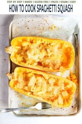 Two scraped spaghetti squash halves on a baking sheet lined with parchment paper