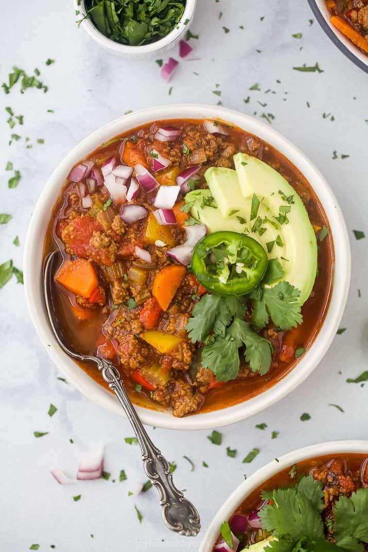 whole30 beef chili in a bowl with toppings and a spoon