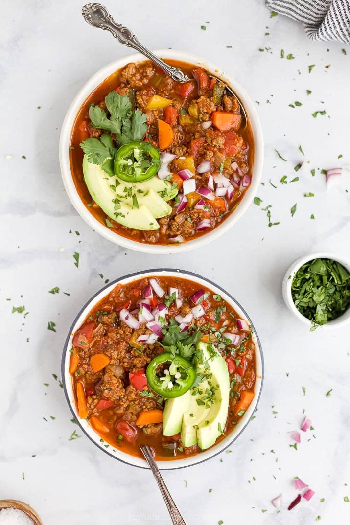 whole30 beef chili in a bowl with spoon and toppings
