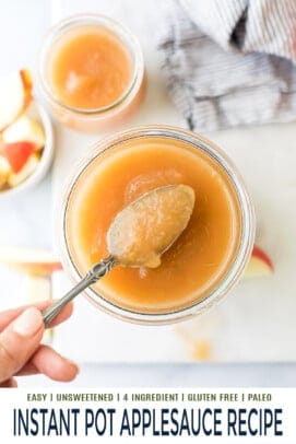 A metal spoon scooping out a bite of homemade applesauce from a jar