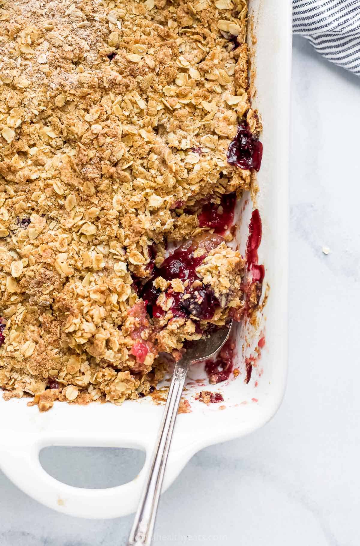 spoon scooping apple blueberry crumble