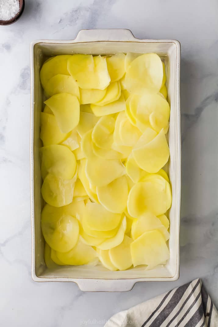 sliced potatoes in a baking dish