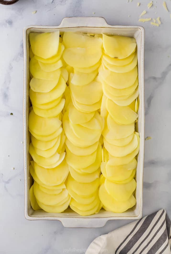 sliced potatoes lined up nicely for scalloped potatoes