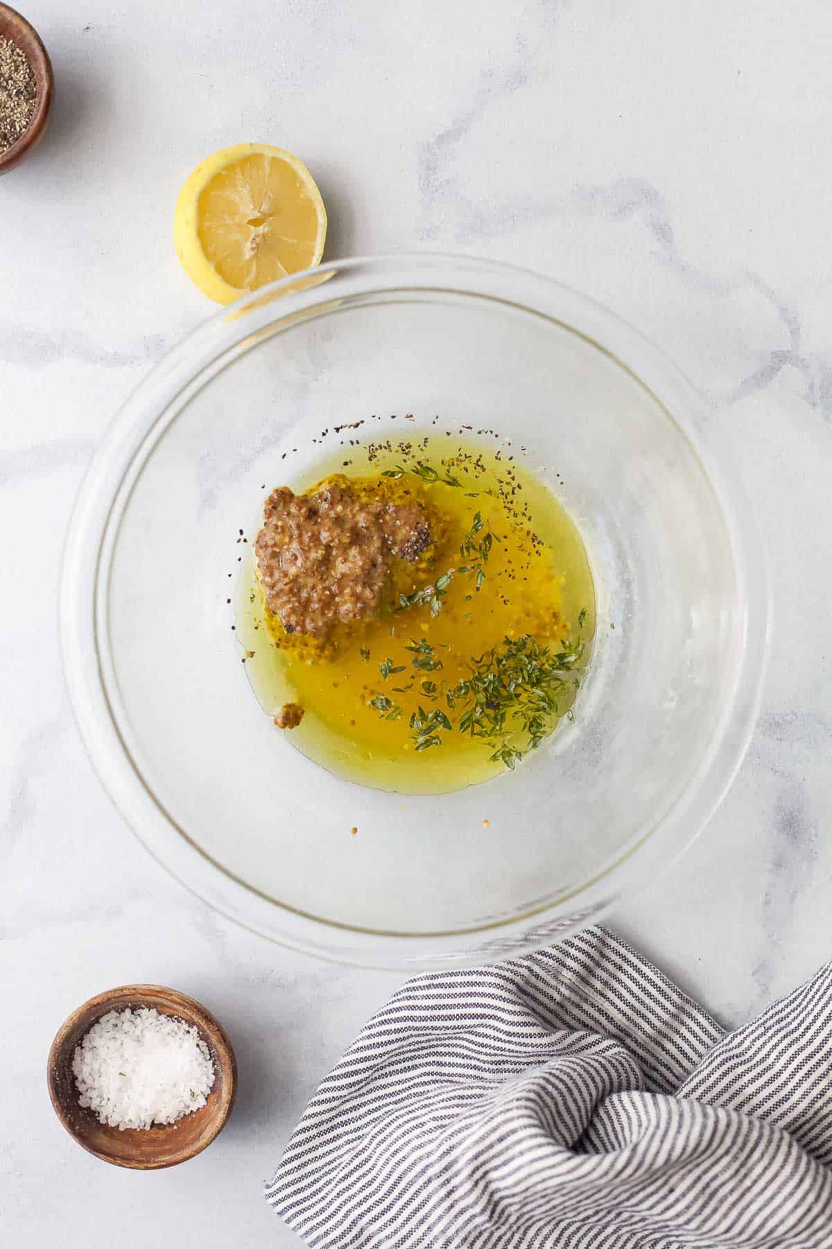 Lemon juice, olive oil, honey, Dijon mustard and the rest of the vinaigrette ingredients in a small glass mixing bowl