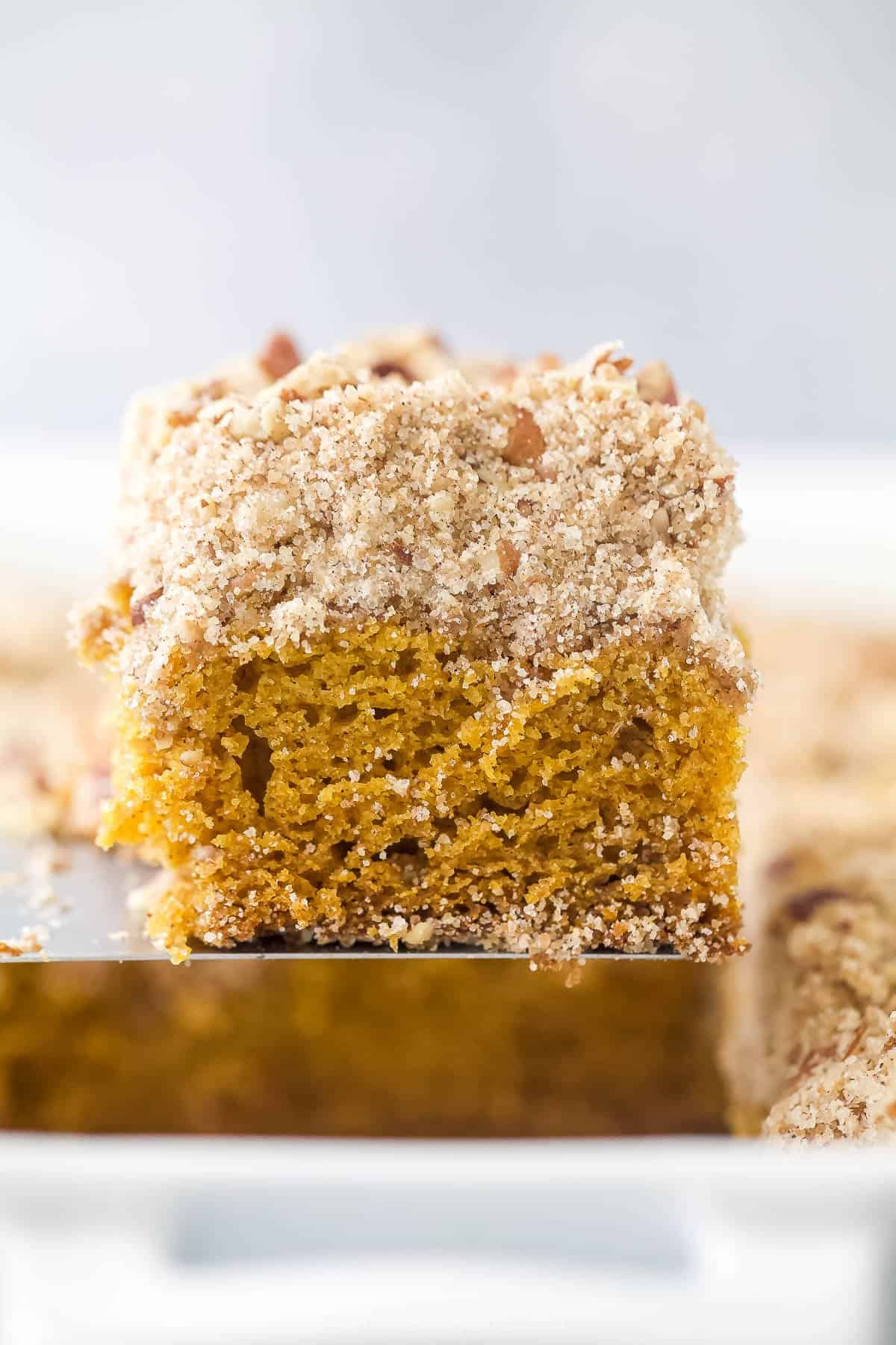 spatula holding a slice of pumpkin spice coffee cake