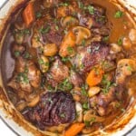 The bird's-eye view of a pot of coq au vin stew on a kitchen countertop