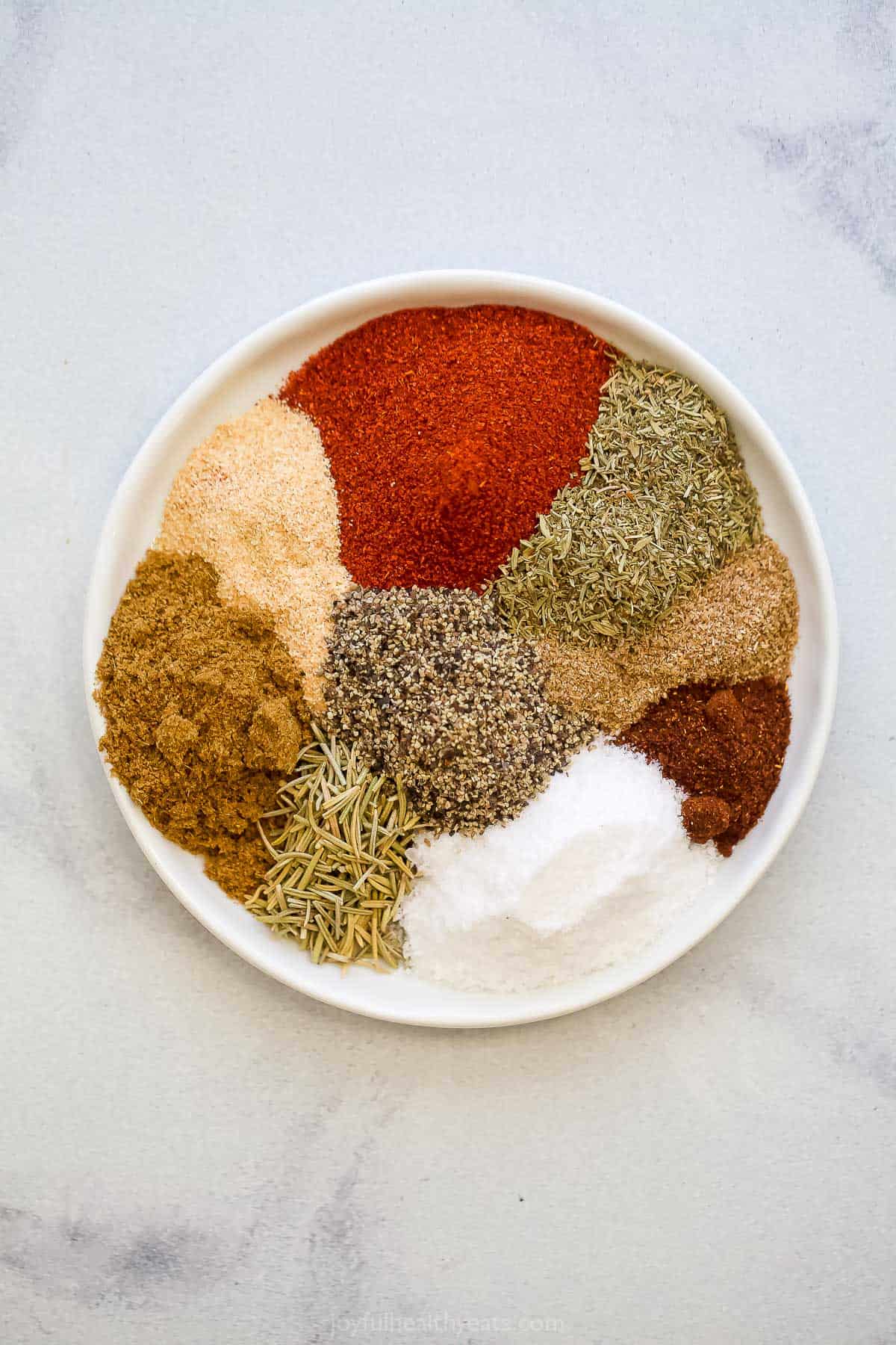 a bunch of spices lined up on a plate