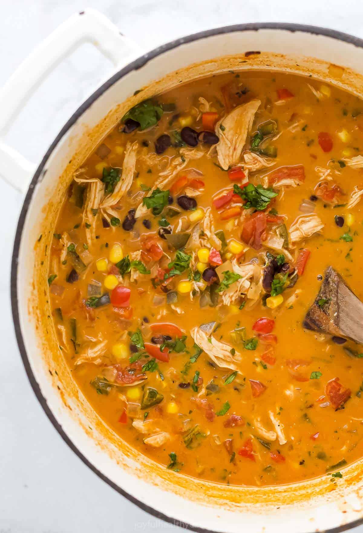 A dutch oven filled with homemade chicken enchilada soup.