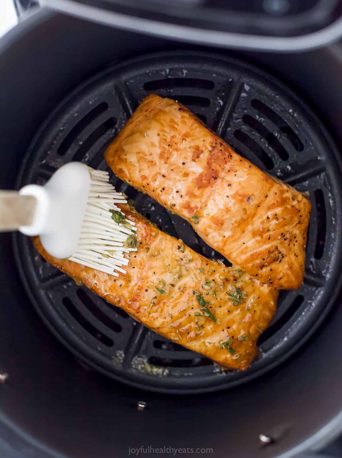 Two filets of salmon brushed with honey garlic sauce.