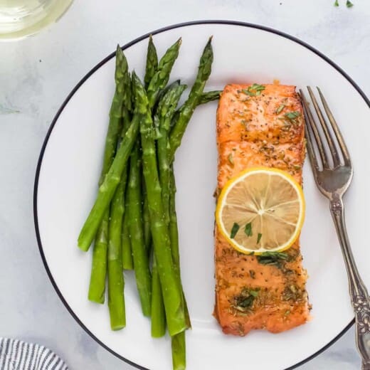 Honey garlic salmon with asparagus on a plate.