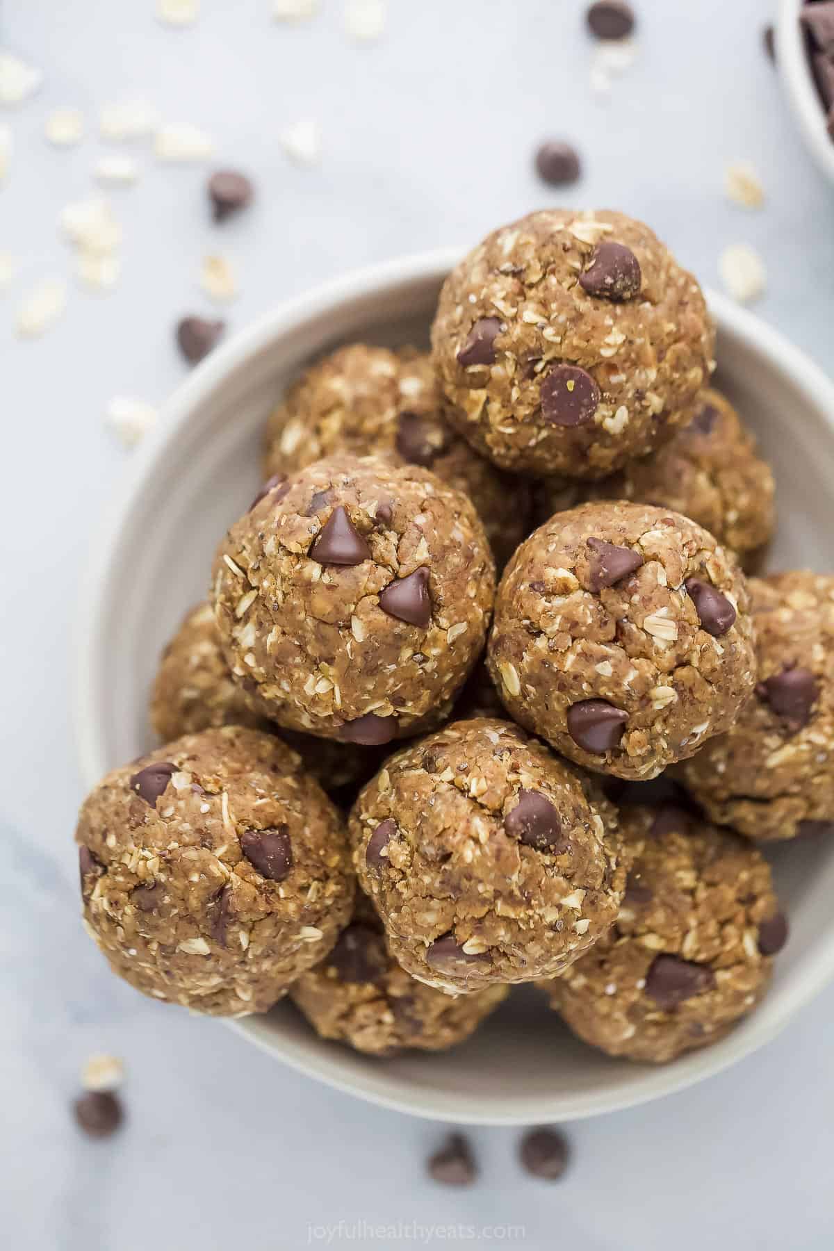 A small white bowl piled high with no-bake chocolate chip energy bites