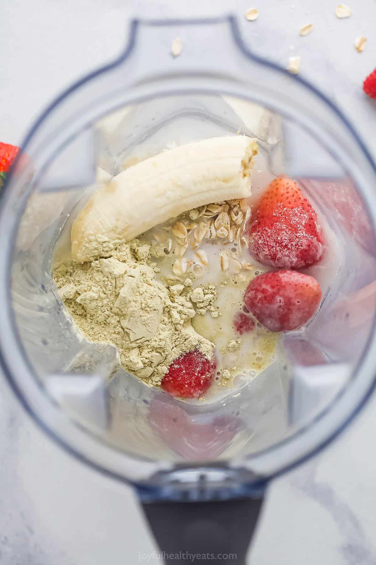 Almond milk, oats, protein powder and the rest of the smoothie ingredients inside of a blender