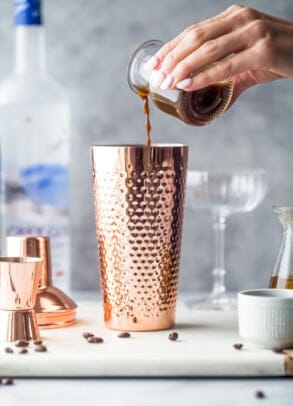 espresso being poured into cocktail shaker