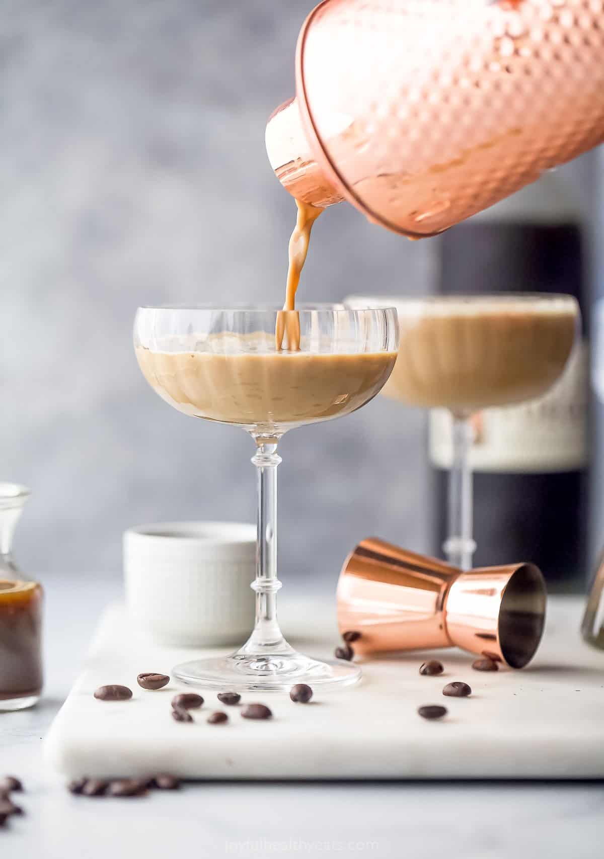 espresso martini being poured into a coupe cup