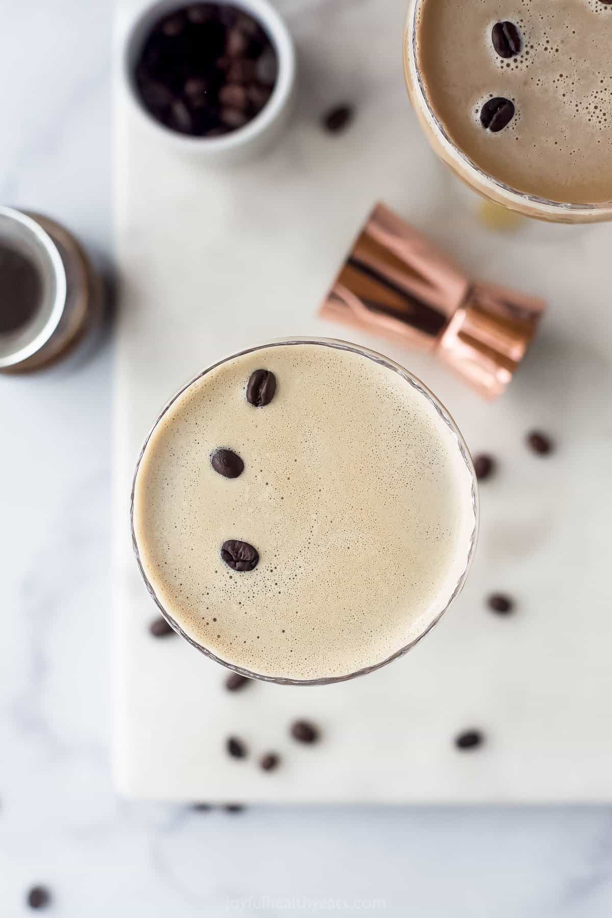 espresso martini in a glass with espresso beans on top