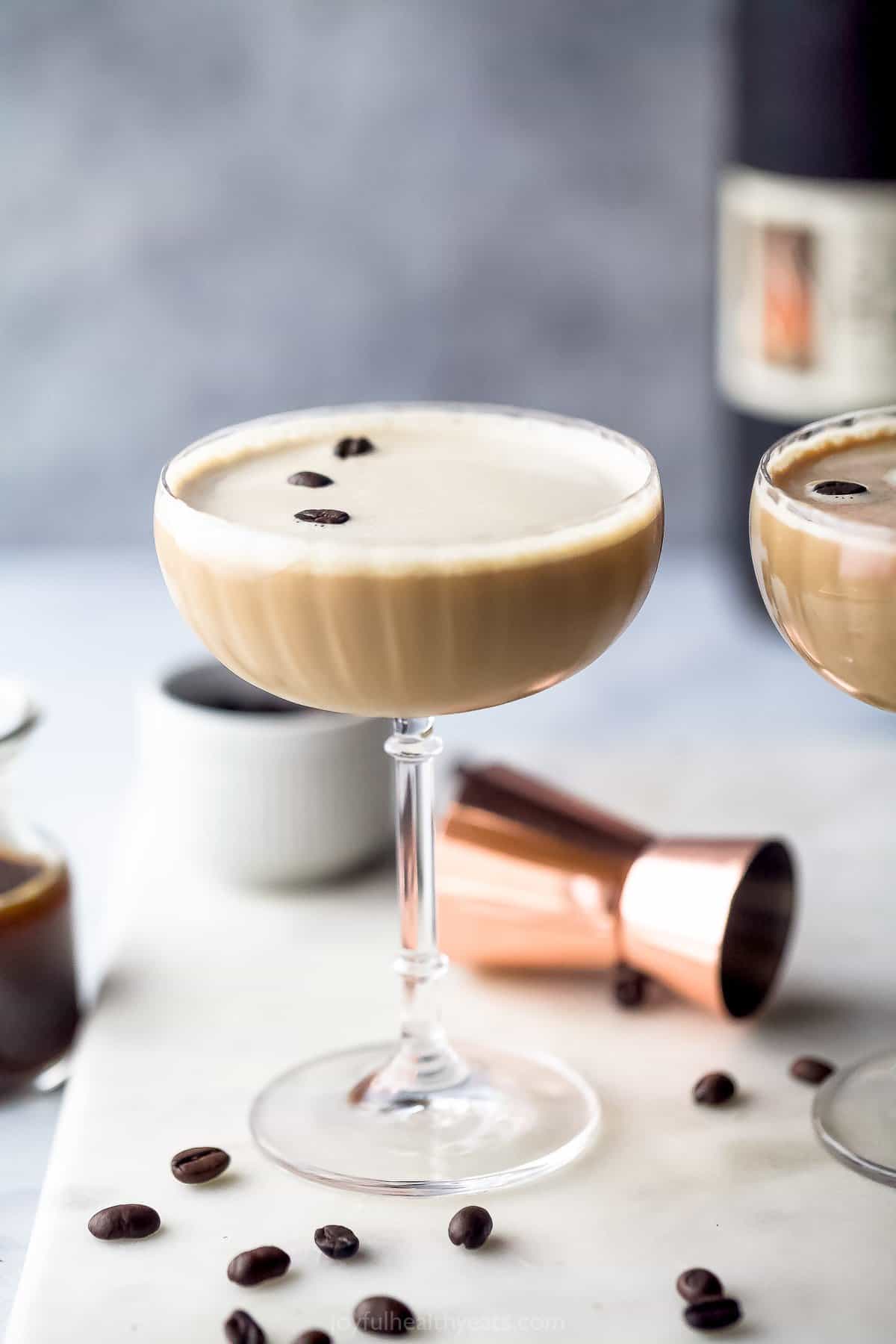 glass filled with espresso martini and topped with espresso beans