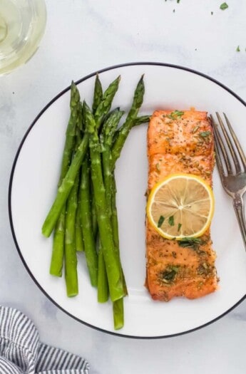 Honey garlic salmon with asparagus on a plate.