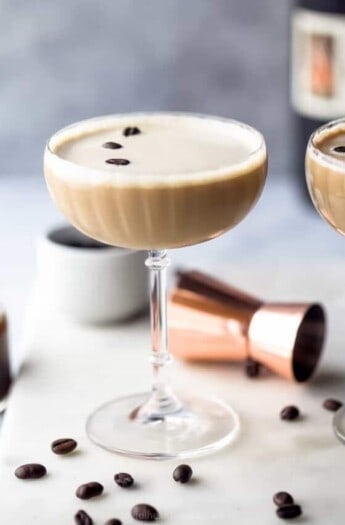 glass filled with espresso martini and topped with espresso beans