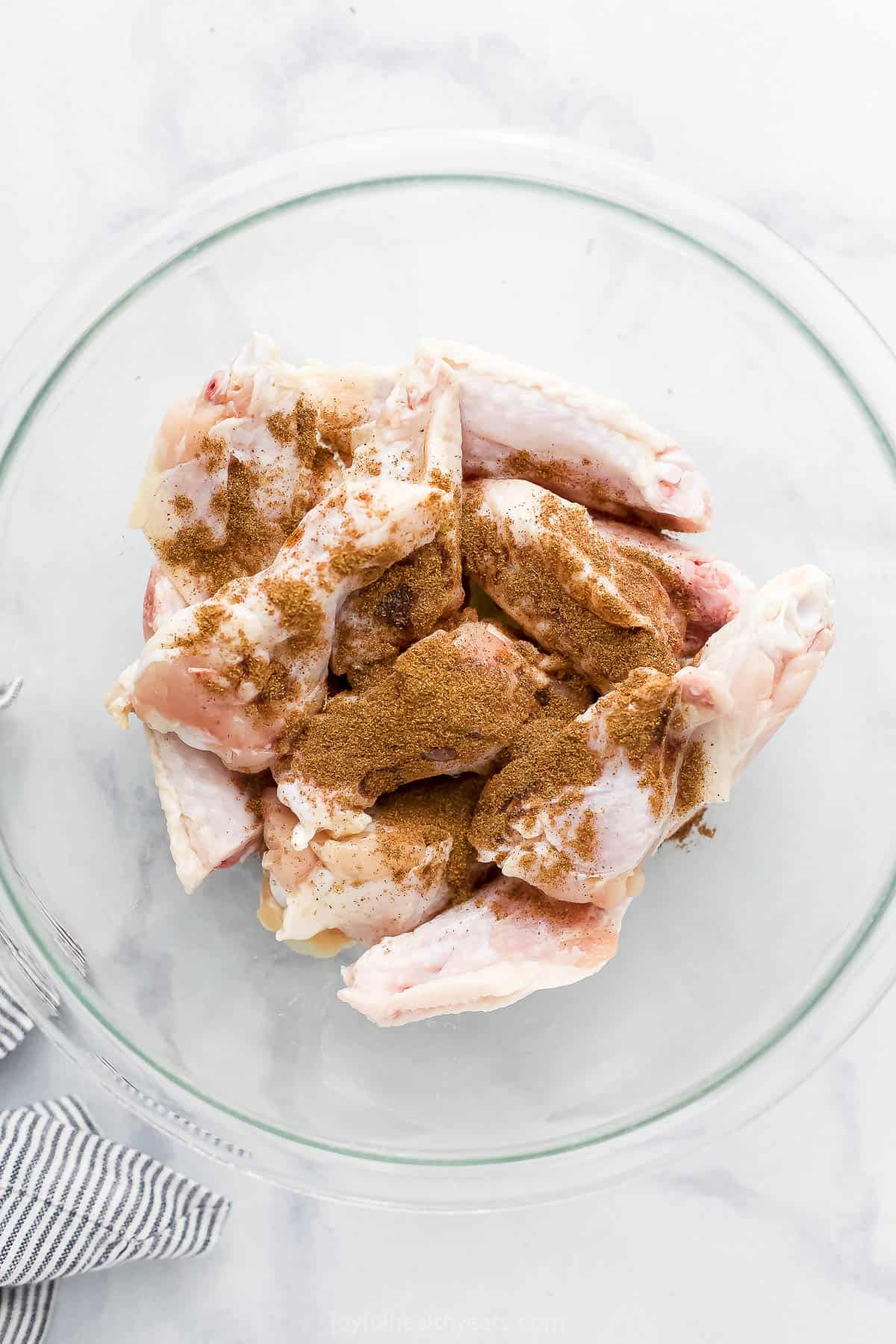 seasoned raw chicken wings in a bowl