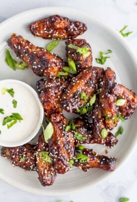 asian baked chicken wings on a plate with ranch