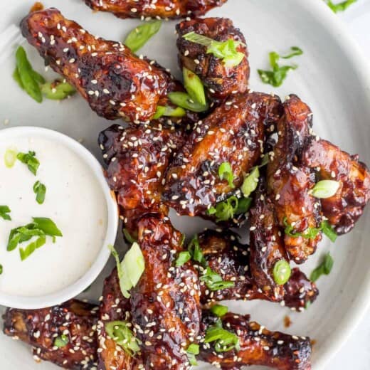 asian baked chicken wings on a plate with ranch