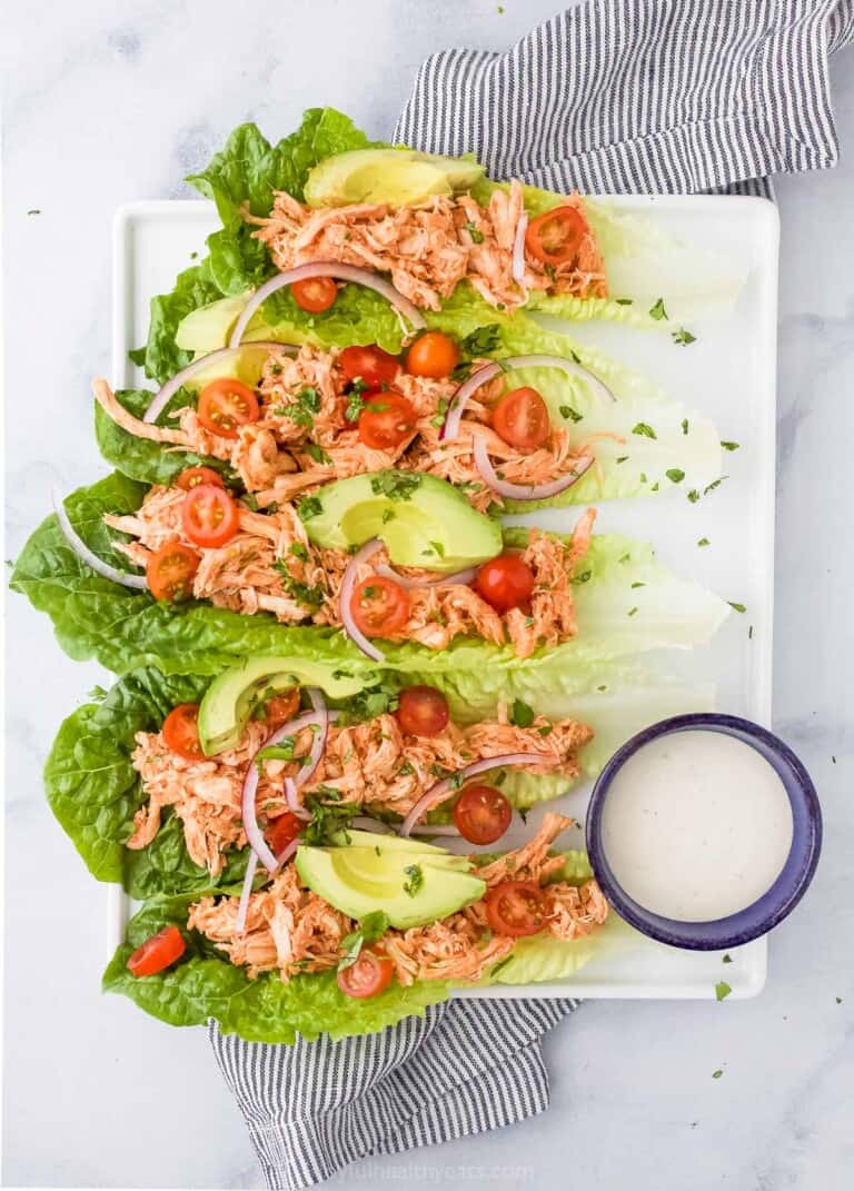 plate filled with buffalo chicken lettuce wraps and a cup with ranch