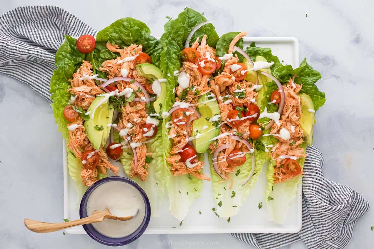 plate filled with buffalo chicken lettuce wraps drizzled with ranch