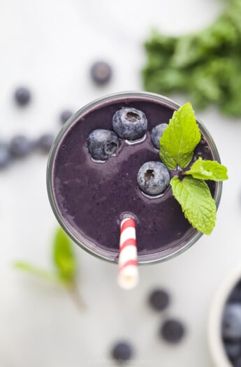 A Blueberry Protein Smoothie Garnished with Mint Leaves and Fresh Blueberries