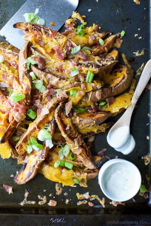 sweet potatoes fries topped with cheese, bacon and green onion