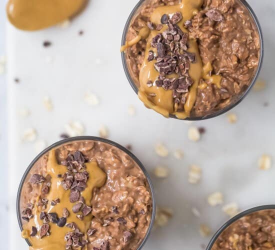 Overhead view of two glass cups of chocolate peanut butter overnight oats