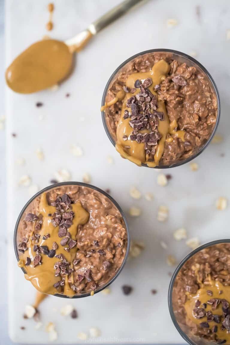 top view of chocolate and peanut butter overnight oats with peanut butter drizzle and chopped chocolate