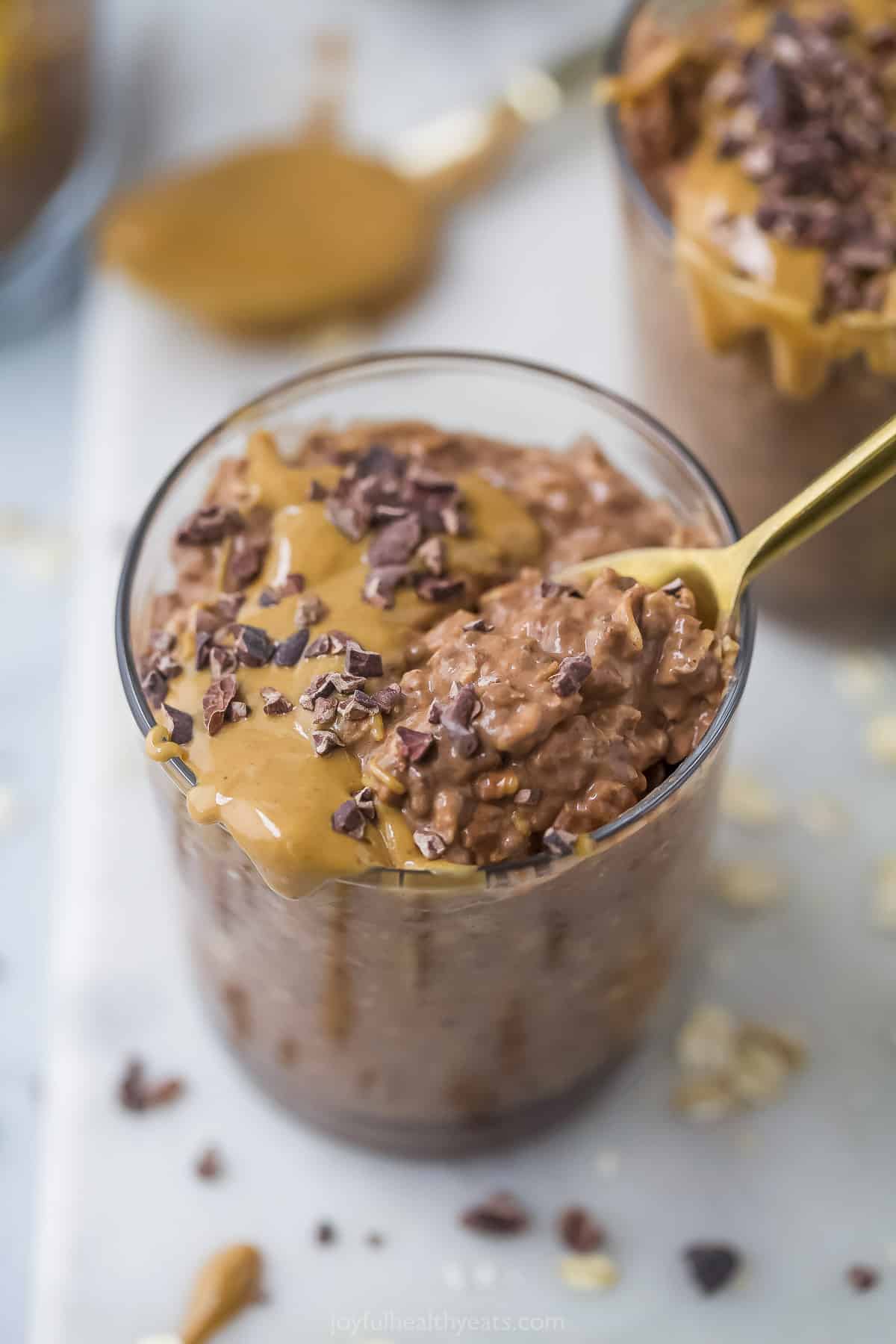 A spoon digging in to chocolate overnight oats