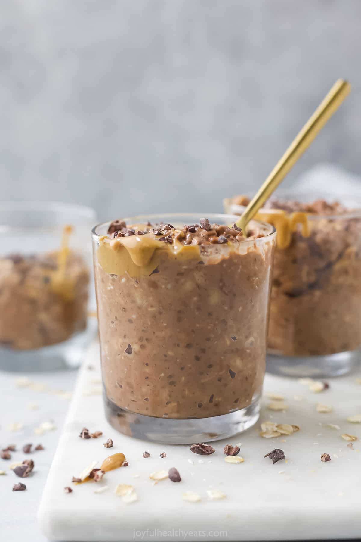 Angled view of glasses of chocolate peanut butter overnight oats