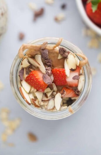 A close-up shot of a jar of vanilla almond overnight oatmeal shown from above